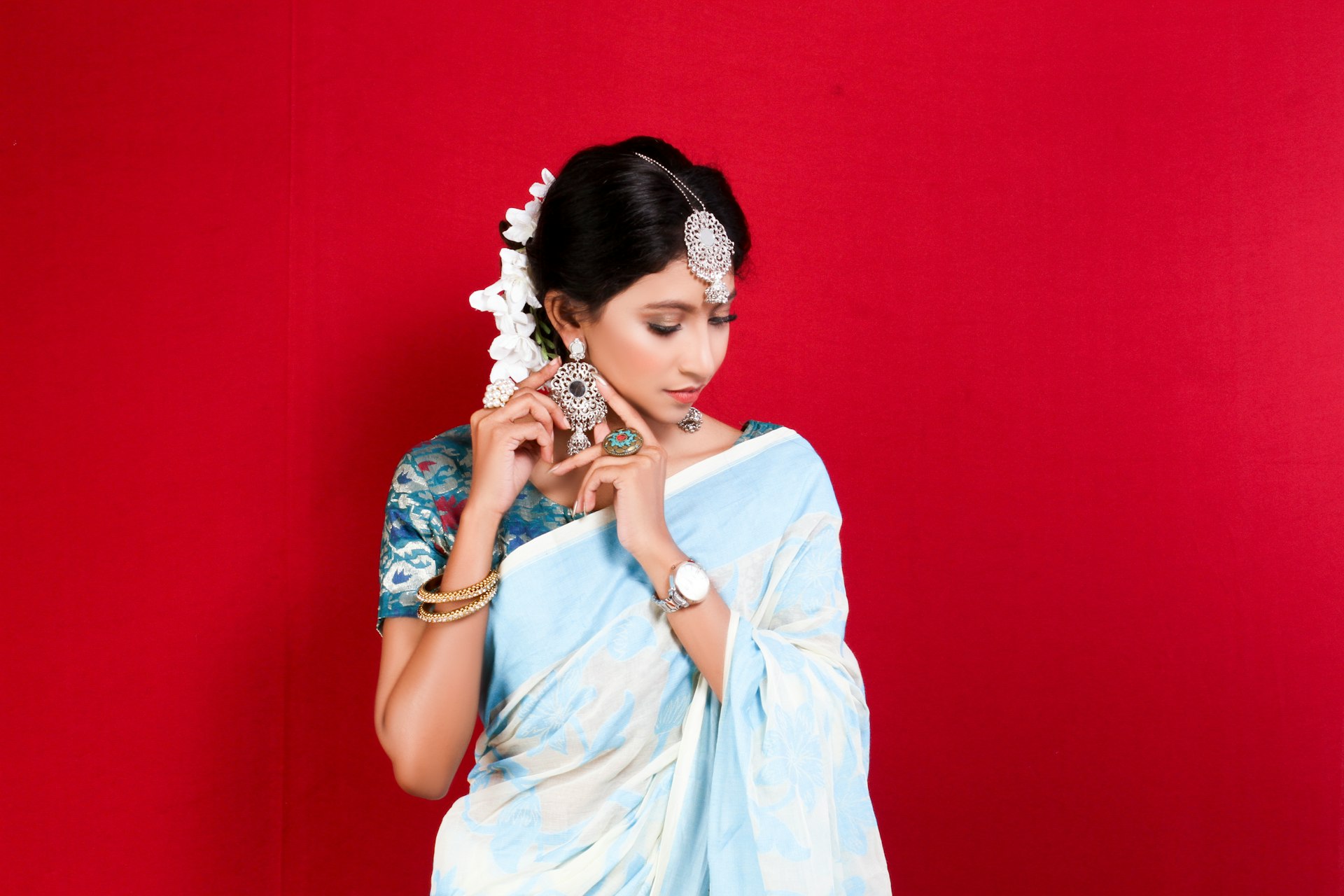 woman in blue dress wearing white floral headdress